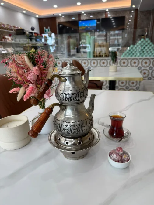 Tea pot served with pomegranate Turkish delight